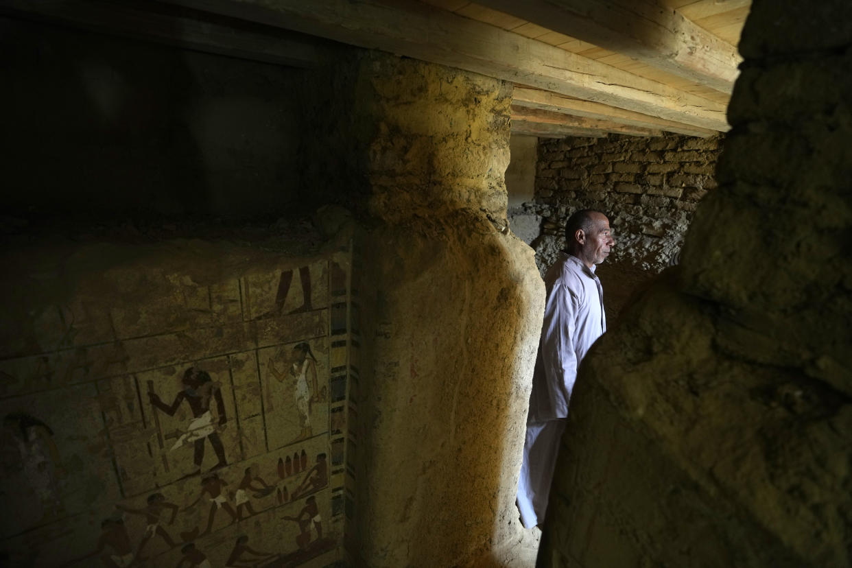 An Egyptian Antiquities guarder stands at a recently discovered tomb dated to the Old Kingdom, 2700–2200 BC, at the site of the Step Pyramid of Djoser in Saqqara, 24 kilometers (15 miles) southwest of Cairo, Egypt, Thursday, Jan. 26, 2023. Egyptian archaeologist Zahi Hawass, the director of the Egyptian excavation team, announced that the expedition found a group of Old Kingdom tombs dating to the fifth and sixth dynasties of the Old Kingdom, indicating that the site comprised a large cemetery. (AP Photo/Amr Nabil)