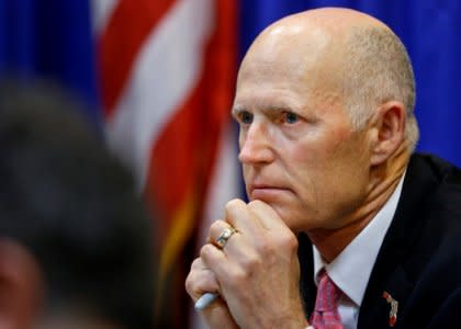 FILE PHOTO: Florida Governor Rick Scott listens during a meeting with law enforcement, mental health, and education officials about how to prevent future tragedies in the wake of last week's mass shooting at Marjory Stoneman Douglas High School, at the Capitol in Tallahassee, Florida, U.S., February 20, 2018.   REUTERS/Colin Hackley/File Photo