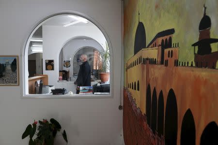 A man stands inside the offices of the The Islamic Movement northern branch in Israel after Israel outlawed the Movement today in Umm al-Faham, northern Israel, November 17, 2015. REUTERS/Ammar Awad