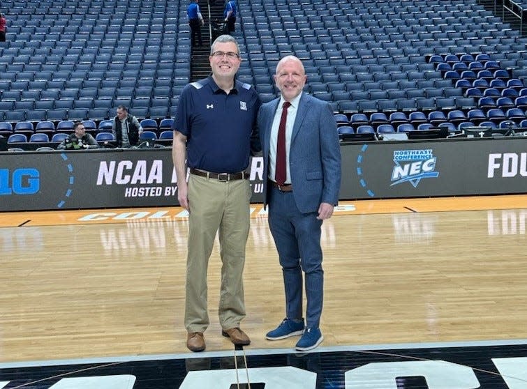 FDU interim president Michael Avaltroni, left, with director of athleics Bradford Hurlbut on the court at Nationwide Arena in Columbus, Ohio after FDU stunned Purdue in the NCAA Tournament