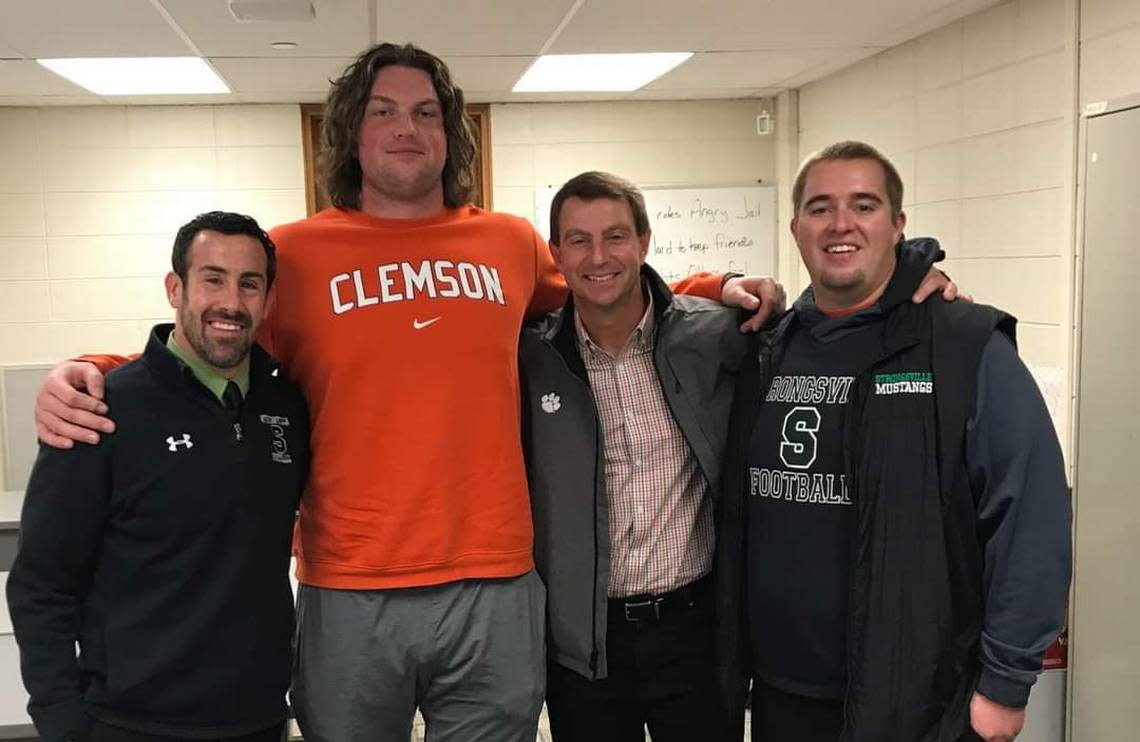 Lou Cirino (left) coached offensive tackle Blake Miller (middle left) for four years at Strongsville High School near Cleveland. Miller’s now the starting right tackle for coach Dabo Swinney (middle right) as a true freshman.