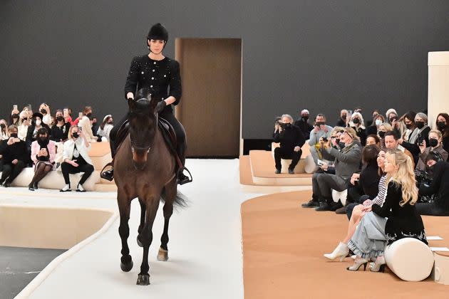 Sofia Coppola looks on as Charlotte and her horse make their way down the runway.  (Photo: Dominique Charriau via Getty Images)