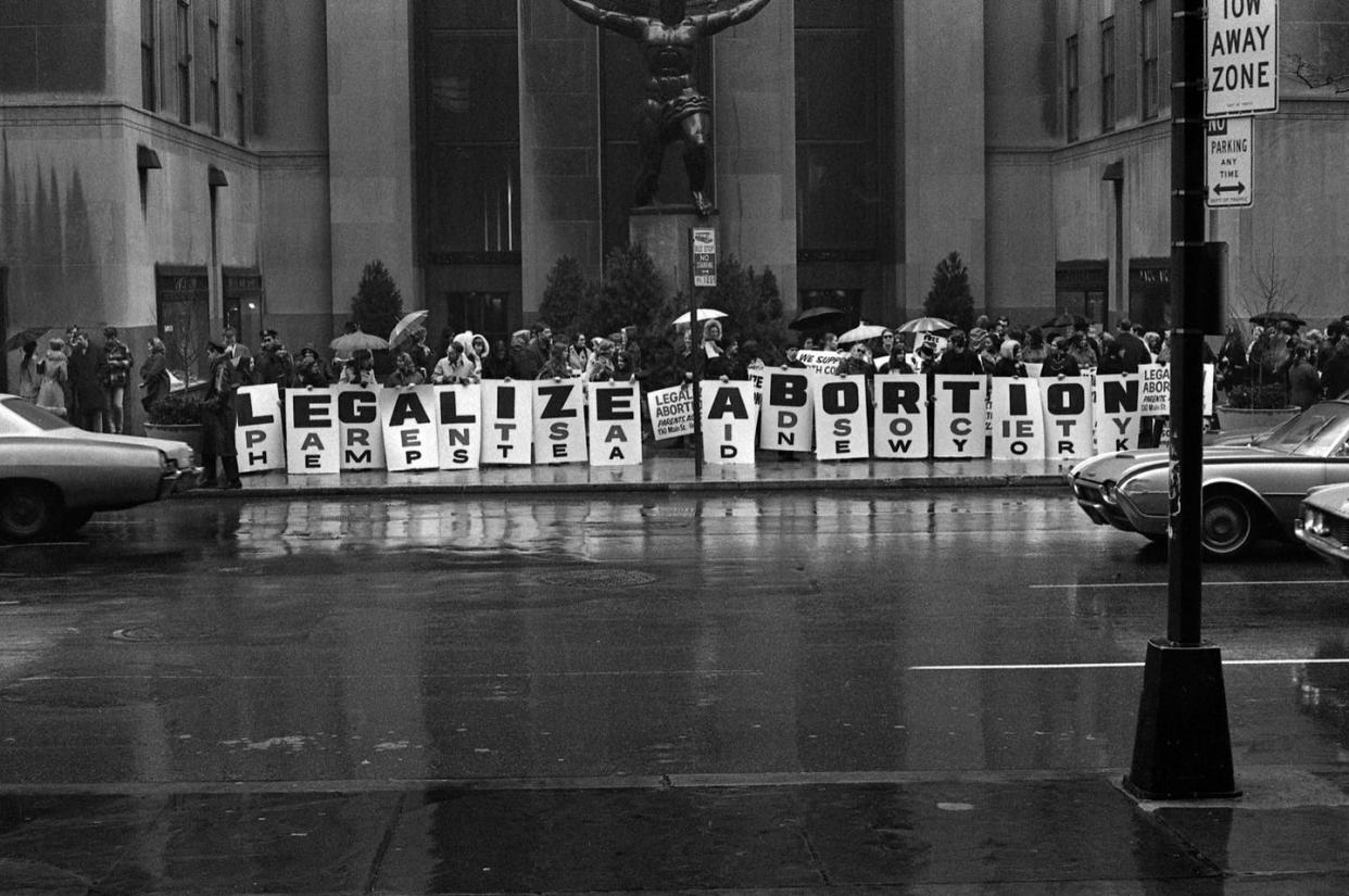 <span class="caption">At New York City's Rockefeller Center, activists hold a series of signs that read 'Legalize Abortion' in March, 1968. </span> <span class="attribution"><a class="link " href="https://www.gettyimages.com/detail/news-photo/in-front-of-the-atlas-sculpture-at-rockefeller-center-news-photo/939586500?adppopup=true" rel="nofollow noopener" target="_blank" data-ylk="slk:Bev Grant/Getty Images;elm:context_link;itc:0;sec:content-canvas">Bev Grant/Getty Images</a></span>