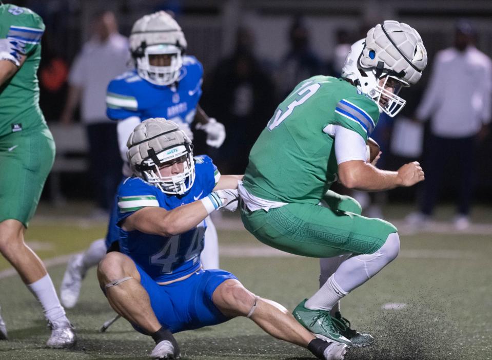 Walker Robinson (44) sacks quarterback Brett Nezat (13) during the spring football game at the University of West Florida in Pensacola on Thursday, March 9, 2023.