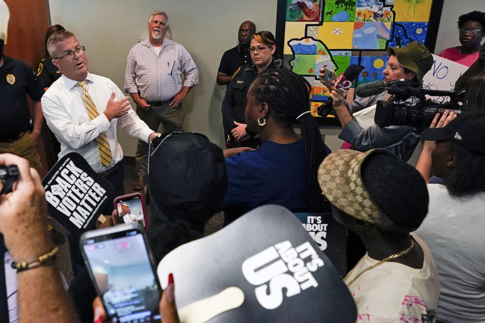State Attorney William Gladson, left, speaks to a group of protesters and the media outside his office at the Marion County Courthouse, Tuesday, June 6, 2023, in Ocala, as protesters demand the arrest of a woman who shot and killed Ajike Owens, a 35-year-old mother of four, last Friday night, June 2. Authorities came under intense pressure Tuesday to bring charges against a white woman who killed Owens, a Black neighbor, on her front doorstep, as they navigated Florida’s divisive stand your ground law that provides considerable leeway to the suspect in making a claim of self defense. (AP Photo/John Raoux)
