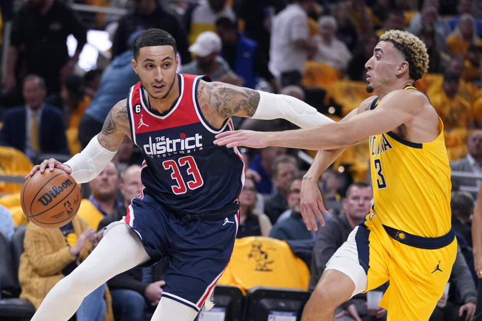 Washington Wizards' Kyle Kuzma (33) goes to the basket against Indiana Pacers' Chris Duarte (3) during the first half of an NBA basketball game Wednesday, Oct. 19, 2022, in Indianapolis. (AP Photo/Michael Conroy)