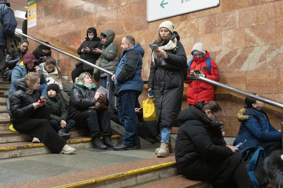 People gather in a subway station being used as a bomb shelter during a Russian rocket attack in Kyiv, Ukraine, Thursday, Jan. 26, 2023.