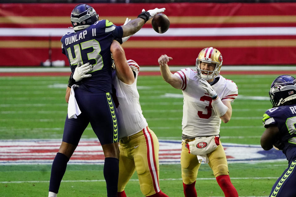 San Francisco 49ers quarterback C.J. Beathard (3) has his pass blocked by Seattle Seahawks defensive end Carlos Dunlap (43) during the first half of an NFL football game, Sunday, Jan. 3, 2021, in Glendale, Ariz. (AP Photo/Rick Scuteri)