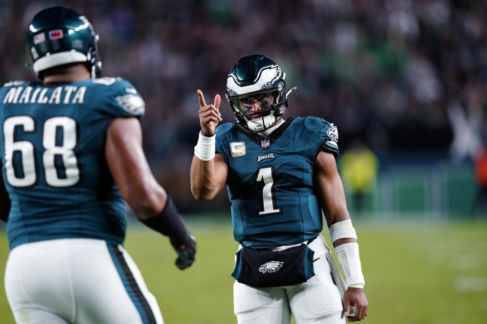 Philadelphia Eagles quarterback Jalen Hurts (1) reacts to his touchdown pass to Eagles' A.J. Brown (11) during the second half of an NFL football game against the Dallas Cowboys on Sunday, Nov. 5, 2023, in Philadelphia. (AP Photo/Chris Szagola)