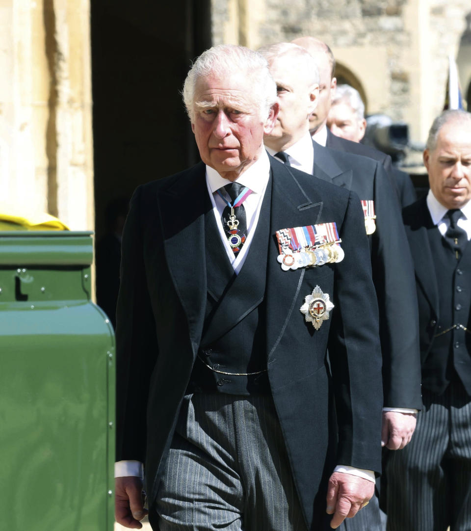 Prince Charles walks behind the Land Rover Defender carrying the Duke of Edinburgh's coffin ahead of his funeral at Windsor Castle, in Windsor, England, Saturday April 17, 2021. Prince Philip died April 9 at the age of 99 after 73 years of marriage to Britain's Queen Elizabeth II. (Ian Vogler/Pool via AP)