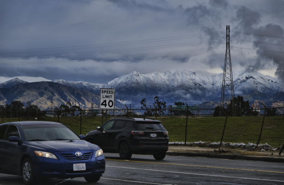 Morning commuters drive with the hills in the background in the Sun Valley section of Los Angeles on Thursday, Dec. 26, 2019. A powerful winter storm brought a deluge of rain and snow to Southern California, triggering tornado warnings and bringing post-Christmas travel to a halt on major routes. (AP Photo/Richard Vogel)