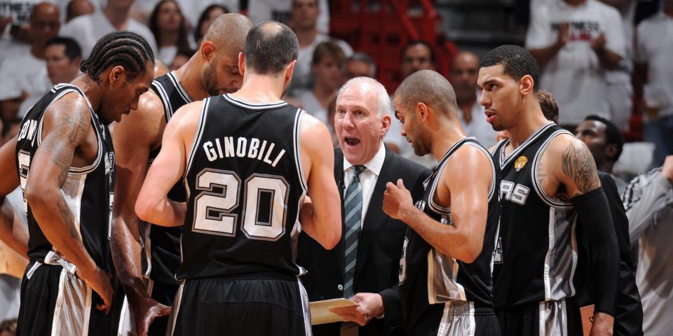 The San Antonio Spurs huddle around Gregg Popovich during the 2014 Finals.