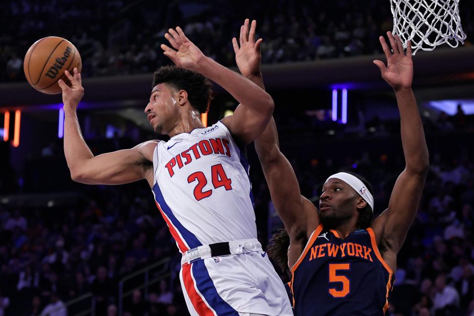 Pistons guard Quentin Grimes passes the ball away from Knicks forward Precious Achiuwa during the first half on Monday, Feb. 26, 2024, in New York.