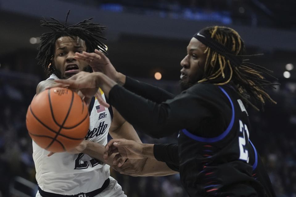 Marquette's David Joplin and DePaul's Da'Sean Nelson go after a loose ball during the first half of an NCAA college basketball game Wednesday, Feb. 21, 2024, in Milwaukee. (AP Photo/Morry Gash)