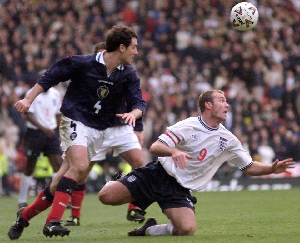 FILE- In this Saturday, Nov. 13 1999 file photo, England's soccer captain Alan Shearer, right, in action against Scotland's Christian Dailly at Glasgow's Hampden Park, Scotland, during their soccer Euro 2000 qualifier, which England won 2-0. While England opened Euro 2020 with a win over Croatia, Scotland lost to the Czech Republic in its first men’s tournament game of the 21st century, but international soccer's oldest rivalry will rise again when England plays Scotland at Wembley Stadium Friday June 18, 2021. (AP Photo/Max Nash, File)