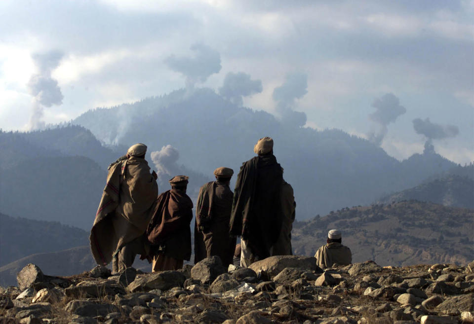 Image: AFGHAN FIGHTERS WATCH SEVERAL EXPLOSIONS FROM US BOMBINGS IN THE TORABORA MOUNTAINS. (Erik de Castro / Reuters file)