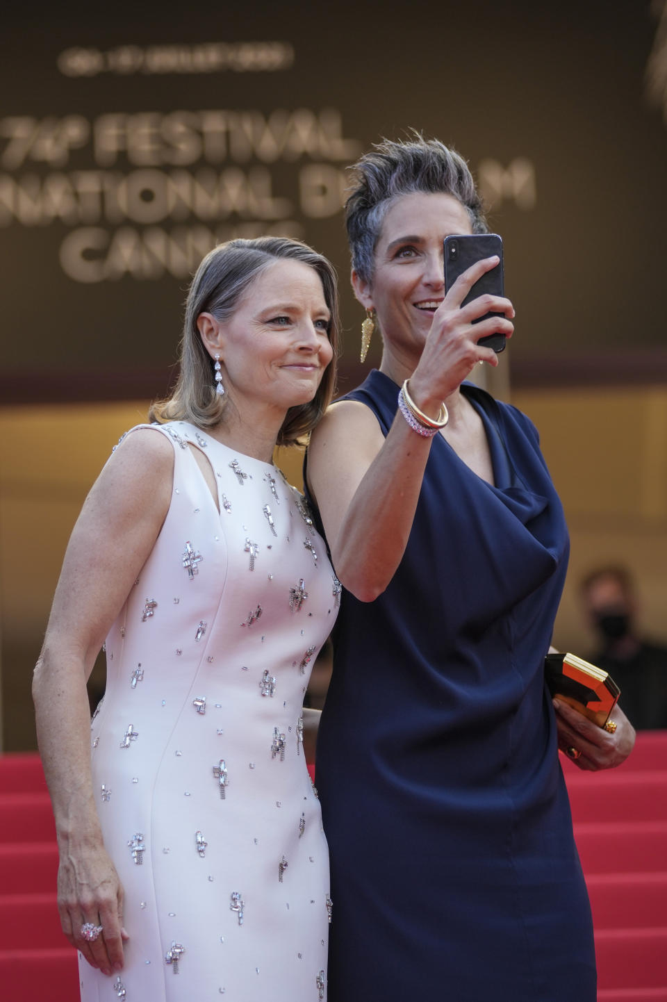 Jodie Foster, left, and Alexandra Hedison pose for photographers upon arrival at the premiere of the film 'Annette' and the opening ceremony of the 74th international film festival, Cannes, southern France, Tuesday, July 6, 2021. (AP Photo/Vadim Ghirda)