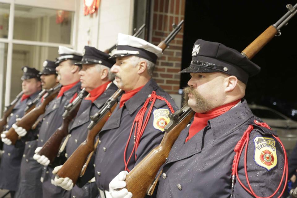 An honor guard stands at attention at the tribute.