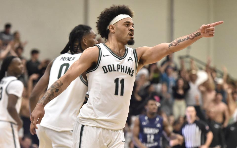 Jacksonville Dolphins guard Marcus Niblack (11) points across the court after sinking a 3-point shot during late seconde half action. Jacksonville University Dolphins hosted the University of North Florida Ospreys in Men's basketball in the historic Swisher Gym Friday night, February 23, 2024. The Ospreys led 25 to 23 at the half. [Bob Self/Florida Times-Union]