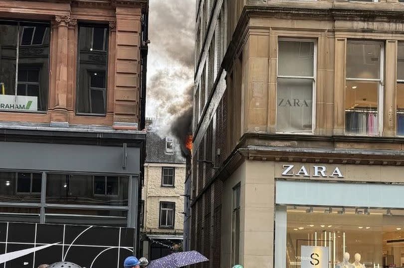 Flames and plumes of smoke can be seen coming from a premises on Buchanan Street