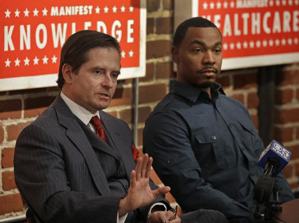 Attorney Christopher Dolan, left, representing the family of Jahi McMath, gestures beside Omari Sealey, Jahi's uncle, during a media conference Monday, Jan. 6, 2014, in San Francisco. Dolan said Monday that a critical care team has delivered Jahi McMath to a new facility, but wouldn't say where it was located. McMath, who had surgery for sleep apnea at Children's Hospital Oakland and then had complications, was declared brain dead on Dec. 12, 2013. McMath left the hospital in a private ambulance shortly before 8 p.m. Sunday. She was moved by a critical care team while attached to a ventilator but without a feeding tube. (AP Photo/Ben Margot)