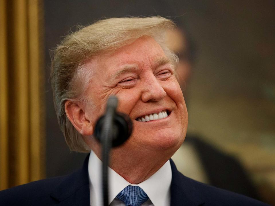 Donald Trump smiles while speaking during a Presidential Medal of Freedom ceremony for former NBA basketball player and coach Bob Cousy of the Boston Celtics in the Oval Office: Alex Brandon/AP