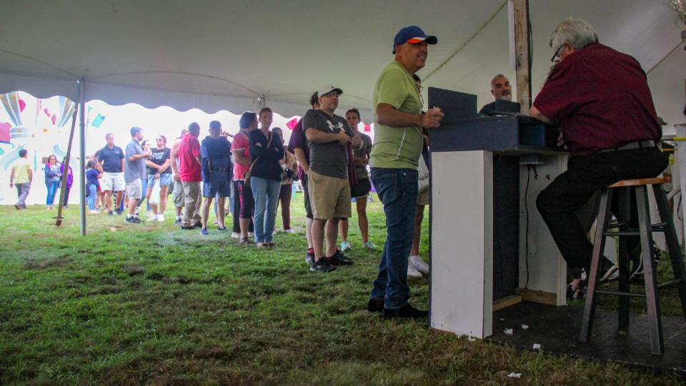 A line for Portuguese food stretches far outside the tent at the Great Feast of the Holy Ghost of New England on Thursday, Aug. 24, in Fall River.