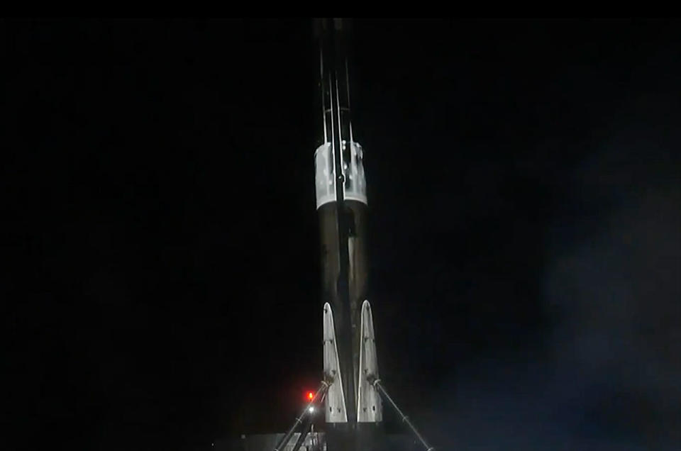 a black and white spacex falcon 9 rocket stands on a droneship after landing.