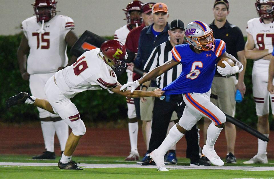 Bolles kick returner Kaleb Lampkins (6) tries to pull away from a tackle against Episcopal.