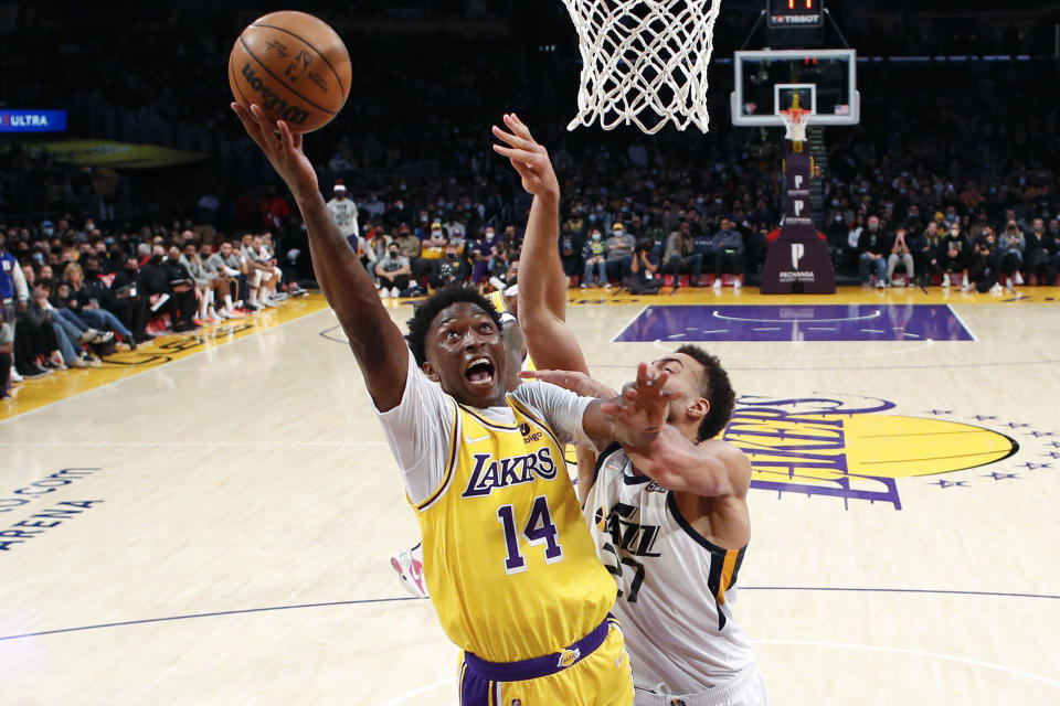 Los Angeles Lakers forward Stanley Johnson (14) goes to basket while defended by Utah Jazz center Rudy Gobert (27) during the second half of an NBA basketball game in Los Angeles, Monday, Jan. 17, 2022. The Lakers won 101-95. (AP Photo/Ringo H.W. Chiu)