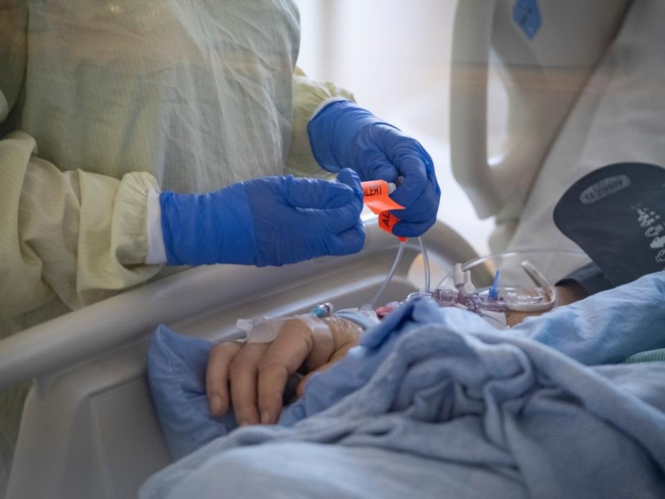 A nurse tends to a patient suspected of having COVID-19 in the intensive care unit at North York General Hospital in Toronto. (Evan Mitsui/CBC - image credit)