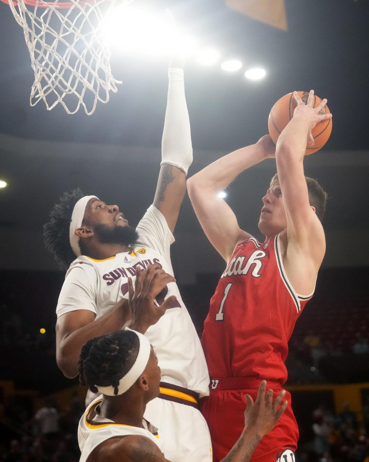 ASU Sun Devils forward Warren Washington (22) defends a shot by Utah Utes forward Ben Carlson (1) at Desert Financial Arena in Tempe on Feb. 18, 2023.