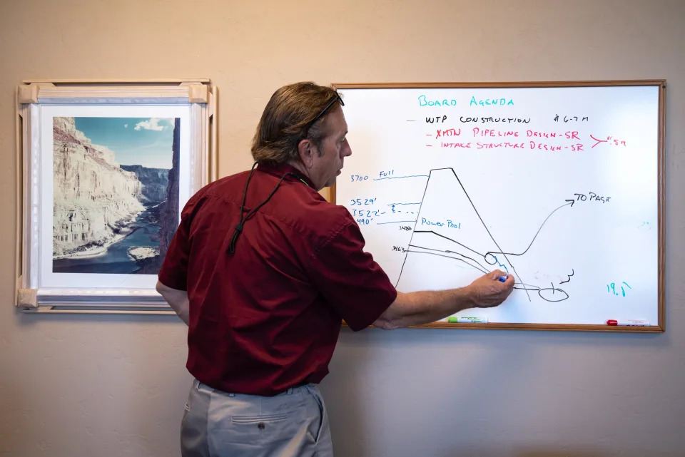 Bryan Hill, general manager of Page Power u0026 Water, draws the Glen Canyon Dam and Page's water supply issues on a whiteboard on May 25, 2022, in his office. Page and neighboring Lechee get water from Lake Powell.