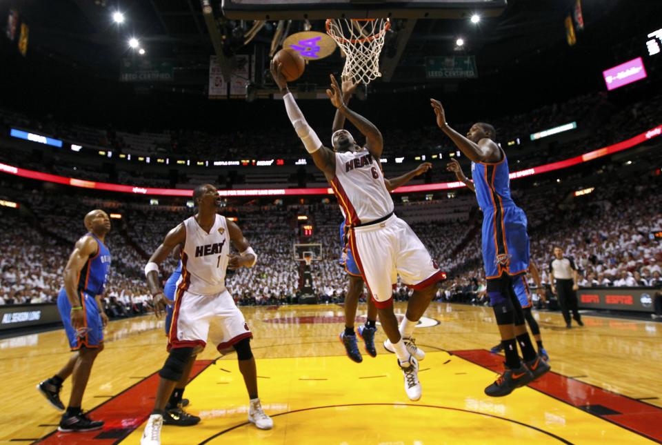 Miami Heat forward LeBron James (C) shoots as Oklahoma City Thunder forward Kevin Durant (R) defends in the first half during Game 4 of the NBA basketball finals in Miami, Florida, June 19, 2012. REUTERS/Mike Ehrmann/POOL (UNITED STATES - Tags: SPORT BASKETBALL)