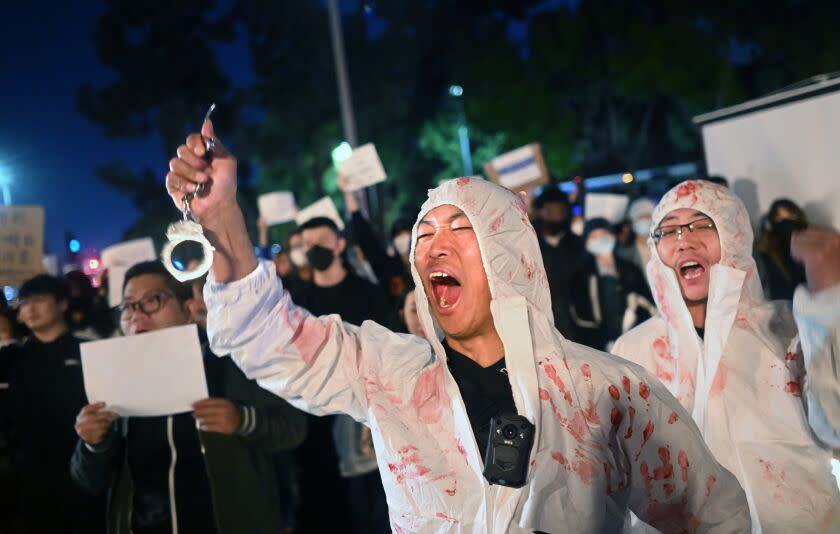 Los Angeles, California November 29, 2022-Lijian Jie yells in protest during a candlelight vigil for victims who suffer under China's stringent lockdown in Urumqi and COVID victims on the campus of USC Tuesday night. (Wally Skalij/Los Angeles Times)