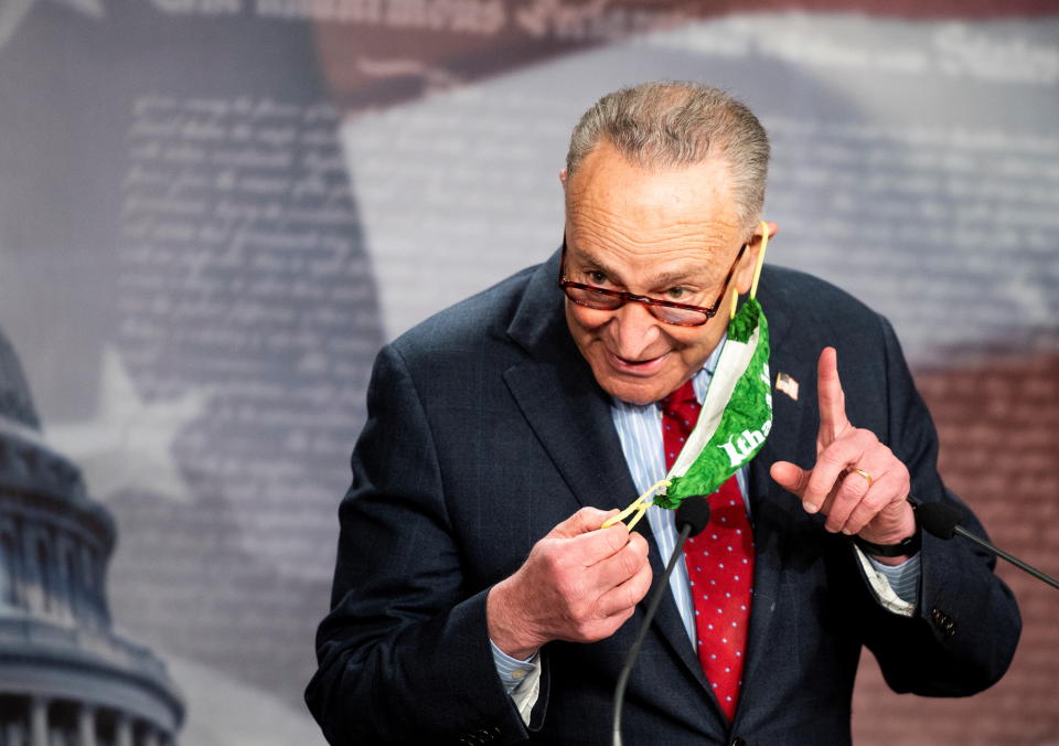 U.S. Senate Majority Leader Chuck Schumer (D-NY) adjusts his face mask as he holds a news conference at the U.S. Capitol in Washington, U.S., March 25, 2021. Bill Clark/Pool via REUTERS.