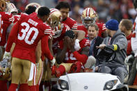 San Francisco 49ers wide receiver Deebo Samuel, middle, reacts as he is carted off the field during the first half of an NFL football game against the Tampa Bay Buccaneers in Santa Clara, Calif., Sunday, Dec. 11, 2022. (AP Photo/Jed Jacobsohn)