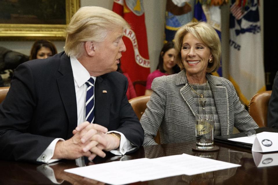 President Donald Trump looks at Education Secretary Betsy DeVos as he speaks during a meeting with parents and teachers, Tuesday, Feb. 14, 2017, in the Roosevelt Room of the White House in Washington. (AP Photo/Evan Vucci)