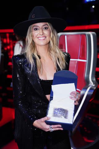 <p>Tyler Golden/NBC</p> Wilson was presented with a belt buckle marking her induction as an Opry member during 'The Voice' finale on May 21
