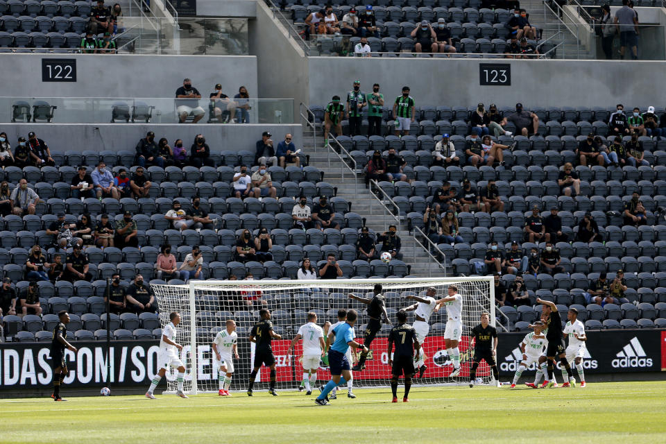 Fans sit in groups of two to four during the first half of an MLS soccer match between Austin FC and Los Angeles FC on Saturday, April 17, 2021, in Los Angeles. (AP Photo/Ringo H.W. Chiu)
