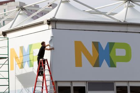 A man works on a tent for NXP Semiconductors in preparation for the 2015 International Consumer Electronics Show (CES) at Las Vegas Convention Center in Las Vegas, Nevada January 4, 2015. REUTERS/Steve Marcus/Files