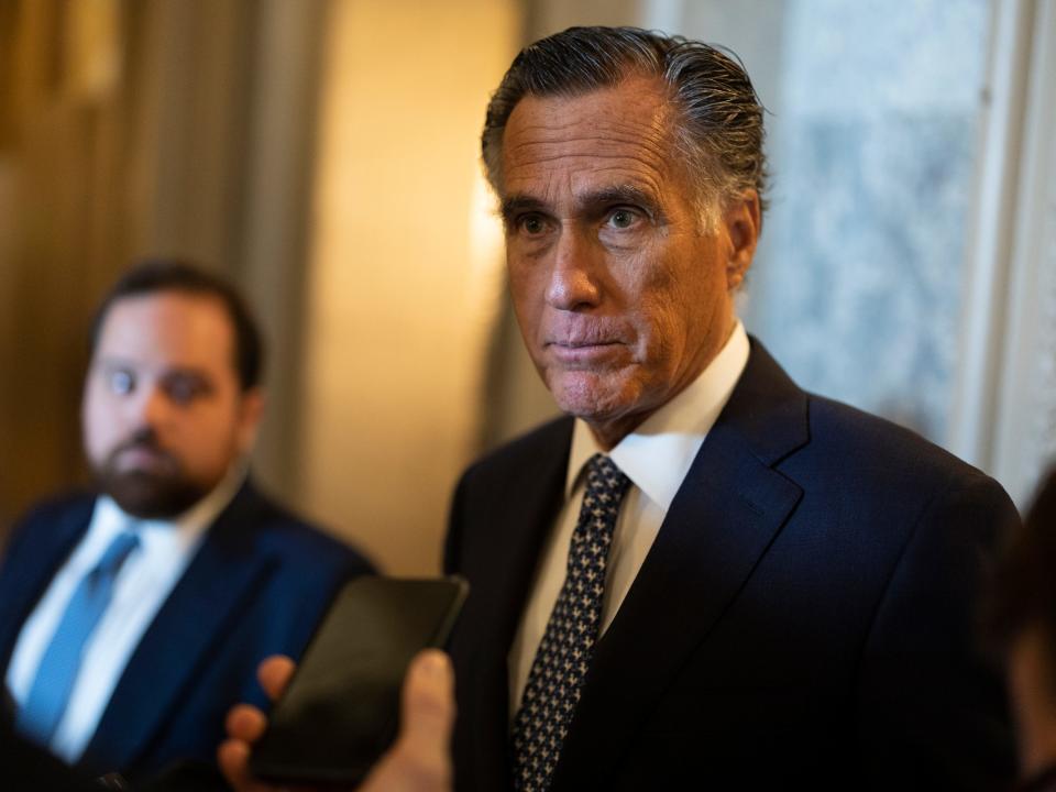 Sen. Mitt Romney speaking to reporters in the capitol building