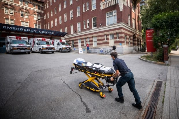 A paramedic outside St. Paul’s Hospital in Vancouver on June 30. According to B.C.'s chief coroner, 570 of the 815 sudden deaths recorded over June's week-long heat wave — 70 per cent — have now been deemed 'heat related.' (Ben Nelms/CBC - image credit)