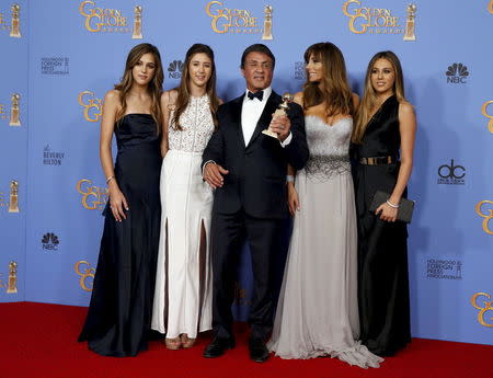 Sylvester Stallone, his wife Jennifer Flavin (2nd R) and their daughters Sistine (L), Scarlet, (2nd L) and Sophia, pose with his award for Best Performance by an Actor in a Supporting Role in any Motion Picture for his role in "Creed" during the 73rd Golden Globe Awards in Beverly Hills, California January 10, 2016. REUTERS/Lucy Nicholson