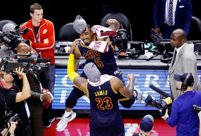 LeBron James (front) and J.R. Smith of the Cleveland Cavaliers celebrate their 113 to 87 win over the Toronto Raptors in game six of the Eastern Conference Finals