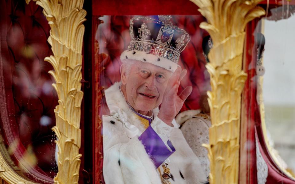King Charles waves from inside the Gold State Coach - Rob Pinney/Getty Images Europe