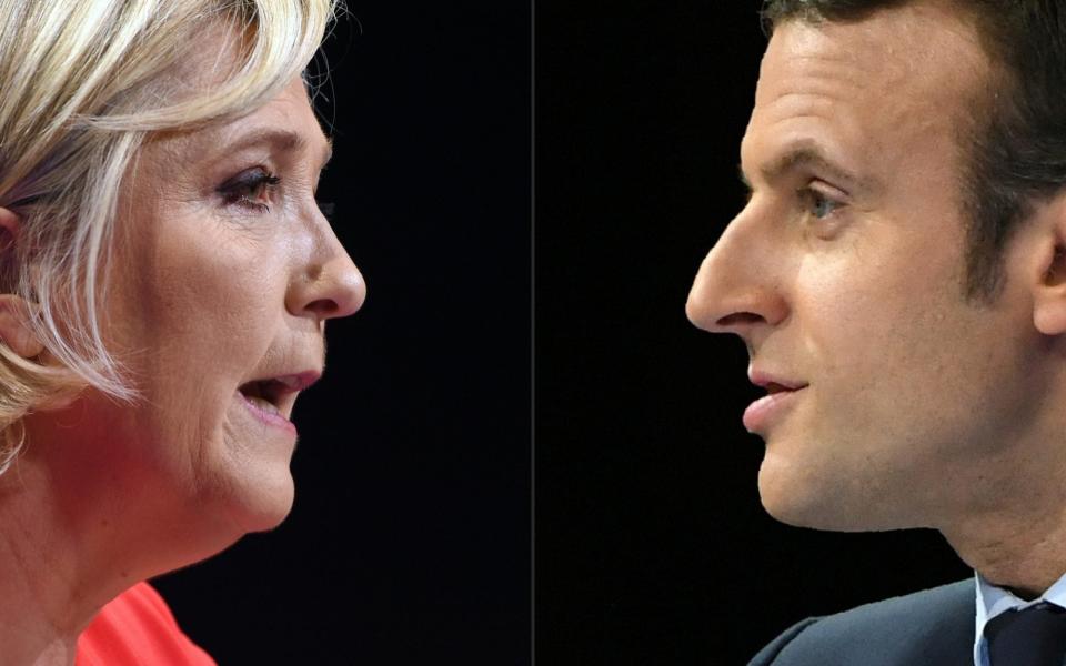 French far-right National Rally party leader Marine Le Pen (L) and French president Emmanuel Macron are polling to clash in next year's elections -  GUILLAUME SOUVANT/ AFP