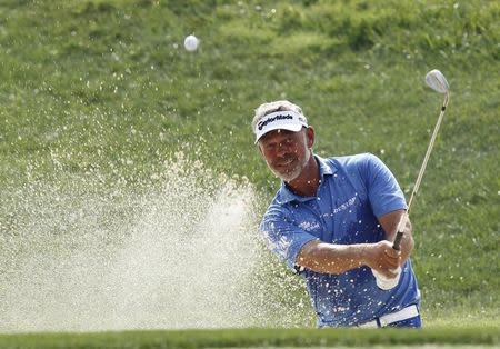 Darren Clarke of Northern Ireland chips onto the 17th green during the third day of practice for the 96th PGA Championship at Valhalla Golf Club in Louisville, Kentucky, August 6, 2014. REUTERS/ John Sommers II