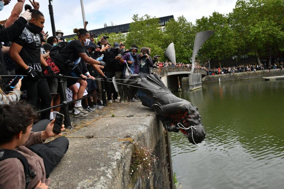 Protesters throwing a statue of Edward Colston into Bristol harbour during the Black Lives Matter protest rally (PA Wire)