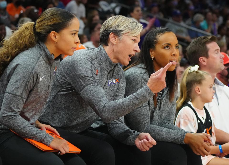 August 12, 2022;  Phoenix, Arizona; USA; Mercury head coach Vanessa Nygaard talks to her assistant coaches during a game at the Footprint Center. Mandatory Credit: Patrick Breen-Arizona Republic